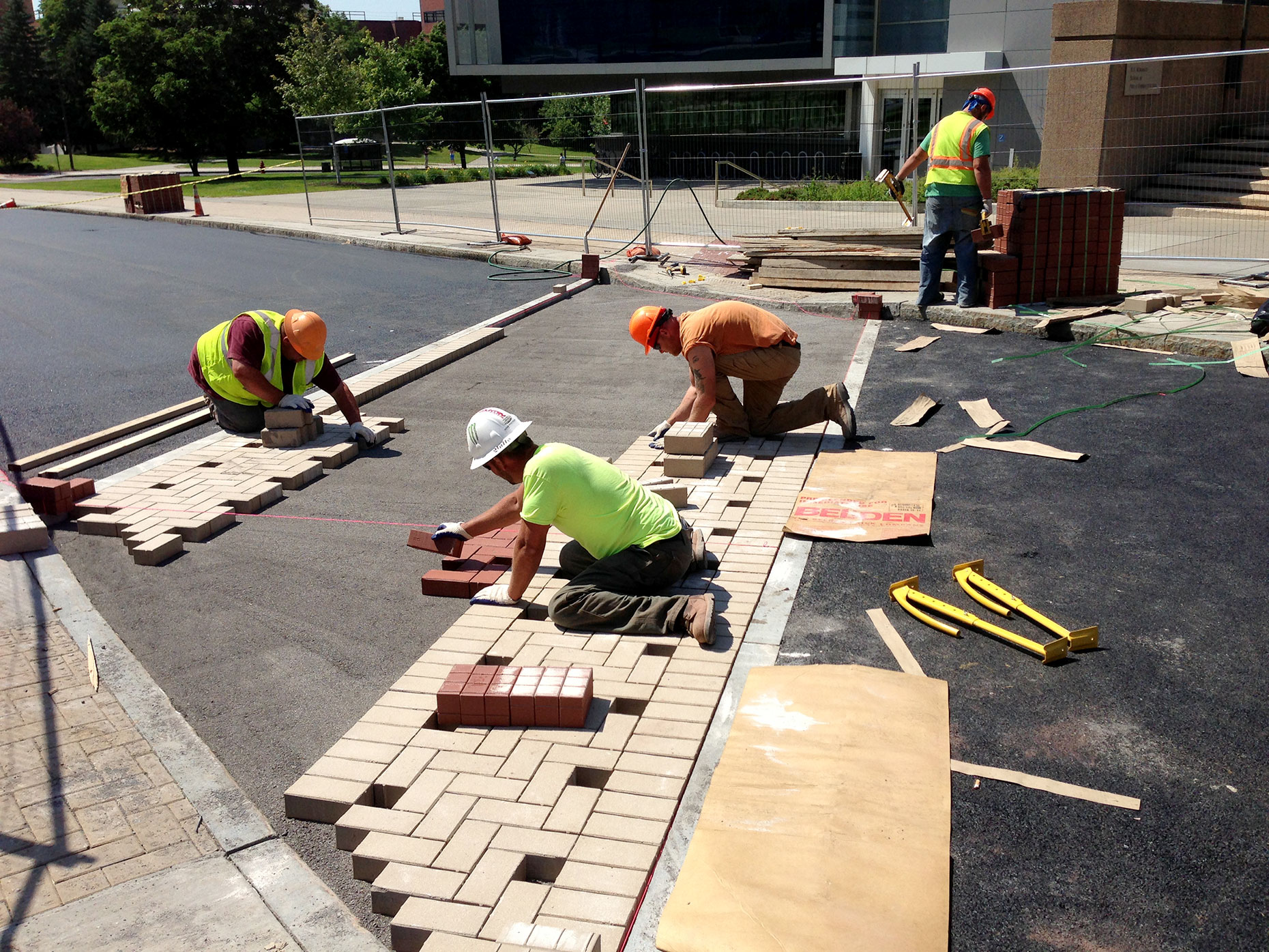 Workers aligning bricks